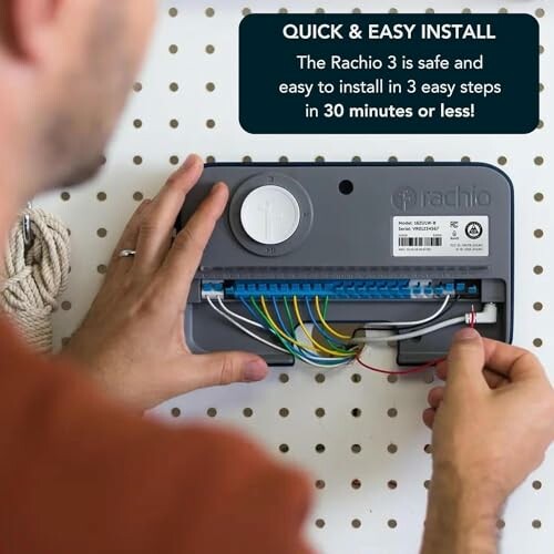 Person installing a Rachio irrigation controller on a wall.